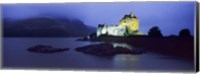 Framed Castle lit up at dusk, Eilean Donan Castle, Loch Duich, Dornie, Highlands Region, Scotland