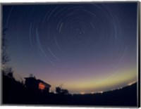 Framed Circumpolar star trails with a faint aurora over horizon, Alberta, Canada
