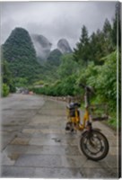 Framed Bicycle sits in front of the Guilin Mountains, Guilin, Yangshuo, China