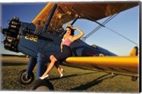 Framed 1940's style pin-up girl sitting on the wing of a Stearman biplane