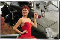 Framed Redhead pin-up girl in 1940's style dancer attire holding on to a vintage aircraft propeller