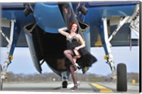 Framed 1940's style pin-up girl in cocktail dress posing in front of a TBM Avenger