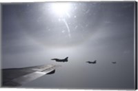 Framed F-16 Fighting Falcon fighters over the wing of a KC-135 Stratotanker