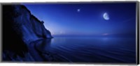 Framed Moon rising over tranquil sea and Mons Klint cliffs, Denmark