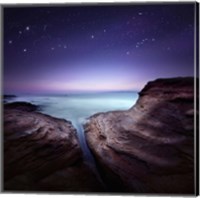 Framed Two large rocks in a sea, against starry sky