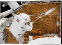 Framed Astronaut works with the Hubble Space Telescope in the cargo bay of Atlantis
