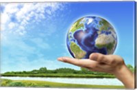 Framed Human Hand Holding Earth Globe with a Green Landscape Background