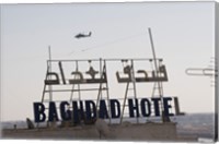 Framed AH-64 Apache in flight over the Baghdad Hotel in central Baghdad, Iraq