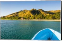 Framed Blue boat cruising through the Yasawa, Fiji, South Pacific