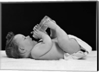 Framed 1950s Baby Lying On Back Drinking From Bottle