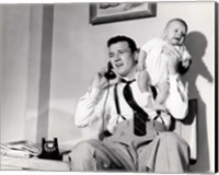 Framed 1950s Father Holding Baby While On The Phone