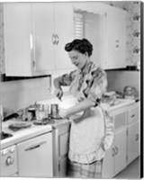 Framed 1950s Housewife In Kitchen Mixing Ingredients