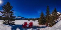 Framed Red Chairs Under a Moonlit Winter Sky at Two Jack Lake
