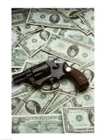 Framed Close-up of a handgun with paper currency