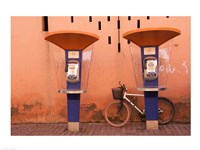 Framed Public telephone booths in front of a wall, Morocco