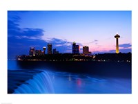 Framed Waterfall with buildings lit up at dusk, American Falls, Niagara Falls, City of Niagara Falls, New York State, USA