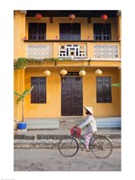 Framed Person riding a bicycle in front of a cafe, Hoi An, Vietnam