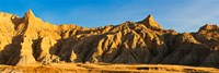 Framed Sculpted sandstone spires in golden light, Saddle Pass Trail, Badlands National Park, South Dakota, USA