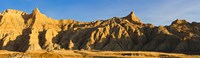 Framed Sculpted sandstone spires in golden light, Saddle Pass Trail, Badlands National Park, South Dakota, USA