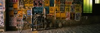 Framed Bicycle leaning against a wall with posters in an alley, Post Alley, Seattle, Washington State, USA