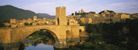 Framed Arch bridge across a river in front of a city, Besalu, Catalonia, Spain