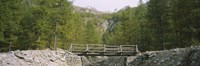 Framed Wooden footbridge across a stream in a mountain range, Switzerland