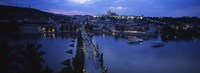 Framed High angle view of buildings lit up at dusk, Charles Bridge, Vltava River, Prague, Czech Republic