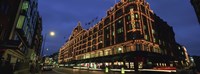 Framed Low angle view of buildings lit up at night, Harrods, London, England