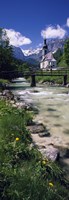 Framed Bridge over stream below country church, Bavarian Alps, Germany.