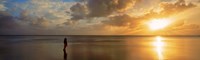 Framed Woman standing on sandbar looking at sunset, Aitutaki, Cook Islands