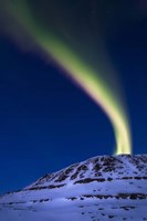 Framed aurora borealis shooting up from Toviktinden Mountain, Norway