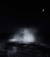 Framed crescent moon and waves splashing over rocks in Miramar, Argentina