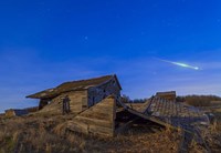 Framed bright bolide meteor breaking up as it enters the atmosphere