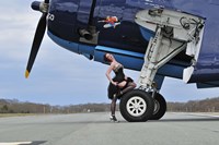 Framed 1940's style pin-up girl resting on the wheel of a TBM Avenger