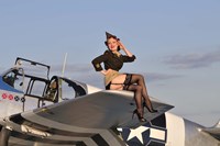 Framed Pin-up girl sitting on the wing of a P-51 Mustang