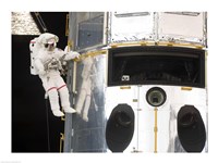 Framed Astronaut performs work on the Hubble Space Telescope