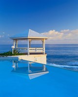 Framed Gazebo reflecting on pool with sea in background, Long Island, Bahamas