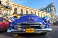 Framed 1950's era car parked on street in Havana Cuba