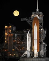 Framed Nearly full Moon Sets as Space Shuttle Discovery Sits Atop the Launch Pad