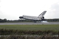 Framed Space Shuttle Discovery Touches Down on the Runway at Kennedy Space Center
