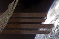 Framed International Space Station's Solar array Panels and Earth's Horizon