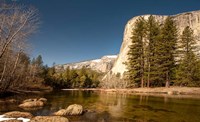 Framed El Capitan towers over Merced River, Yosemite, California