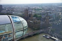 Framed London Eye as it passes Parliament and Big Ben, Thames River, London, England