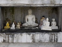 Framed Niche at Ruwanwelisaya Dagoba filled with Buddha statues as offerings, Anuradhapura, Sri Lanka