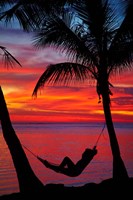 Framed Woman in hammock, and palm trees at sunset, Fiji