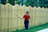 Framed 1980s Smiling Boy Running Along Sidewalk