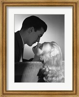 Framed Movie Star Studio Style Romantic Couple Embracing On Sofa About To Kiss