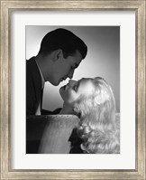 Framed Movie Star Studio Style Romantic Couple Embracing On Sofa About To Kiss