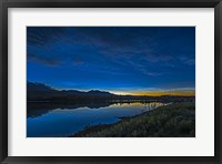 Framed Noctilucent Clouds Glowing and Reflected in Calm Waters of the Waterton River