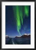 Framed Aurora Over Moonlit Peaks in the Norwegian Sea